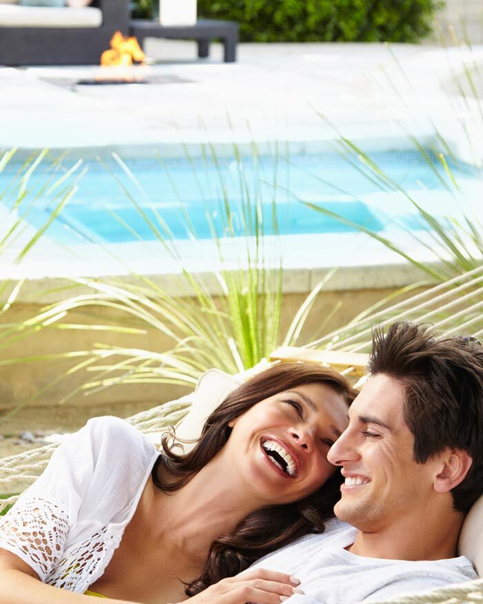 Young couple celebrating their new pool and patio project completion